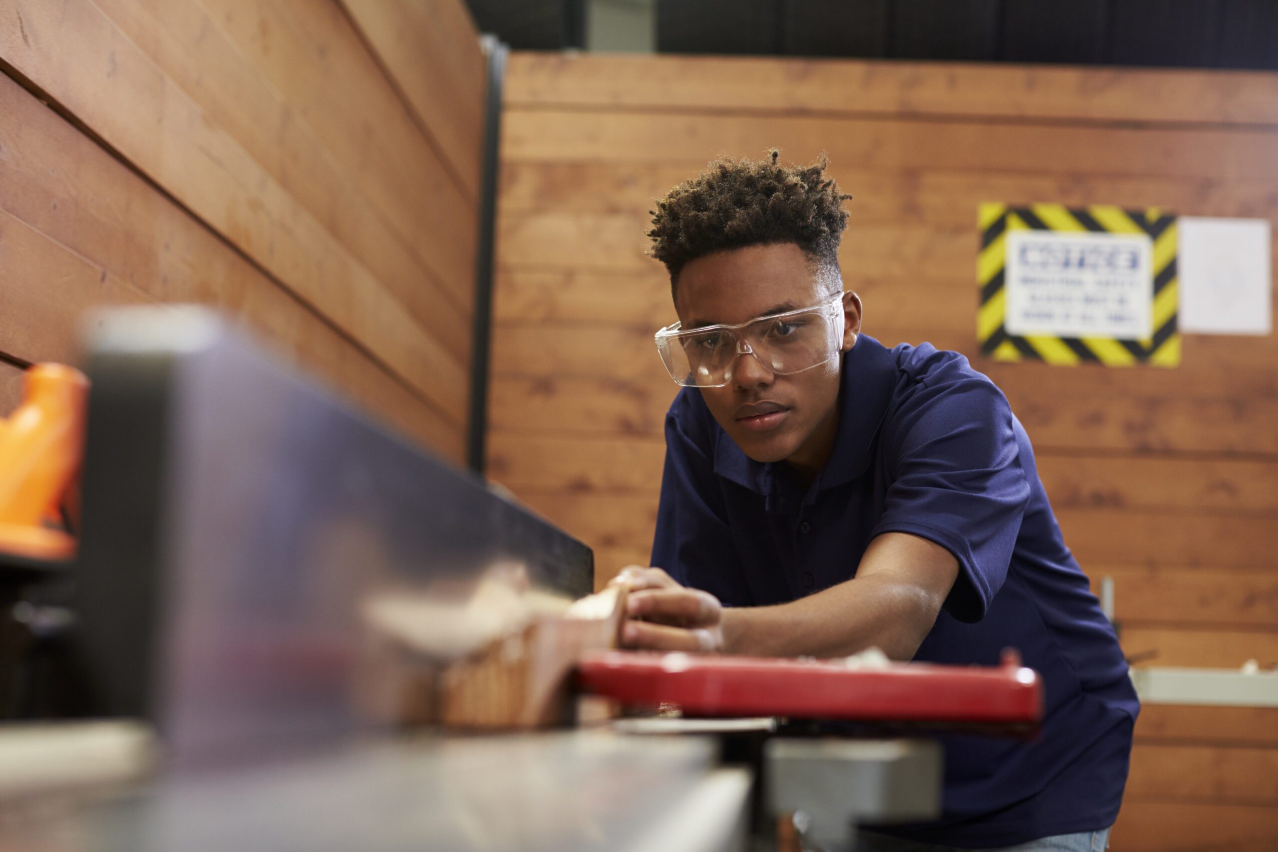 Carpenter Using a joiner In Woodworking Woodshop